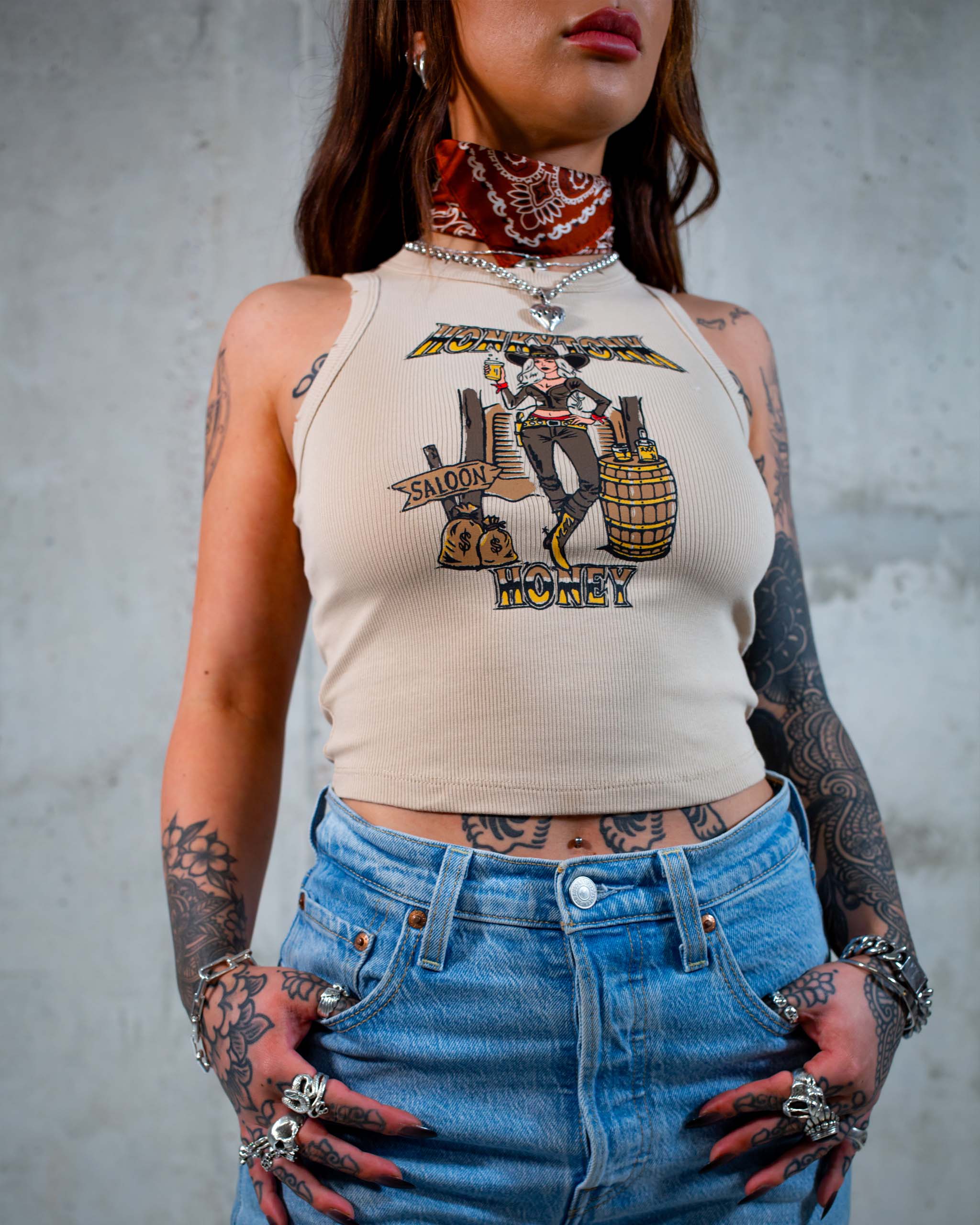 The Honkytonk Honey tank top by Sleazy Rider, featuring a cowgirl outside a wild west saloon.