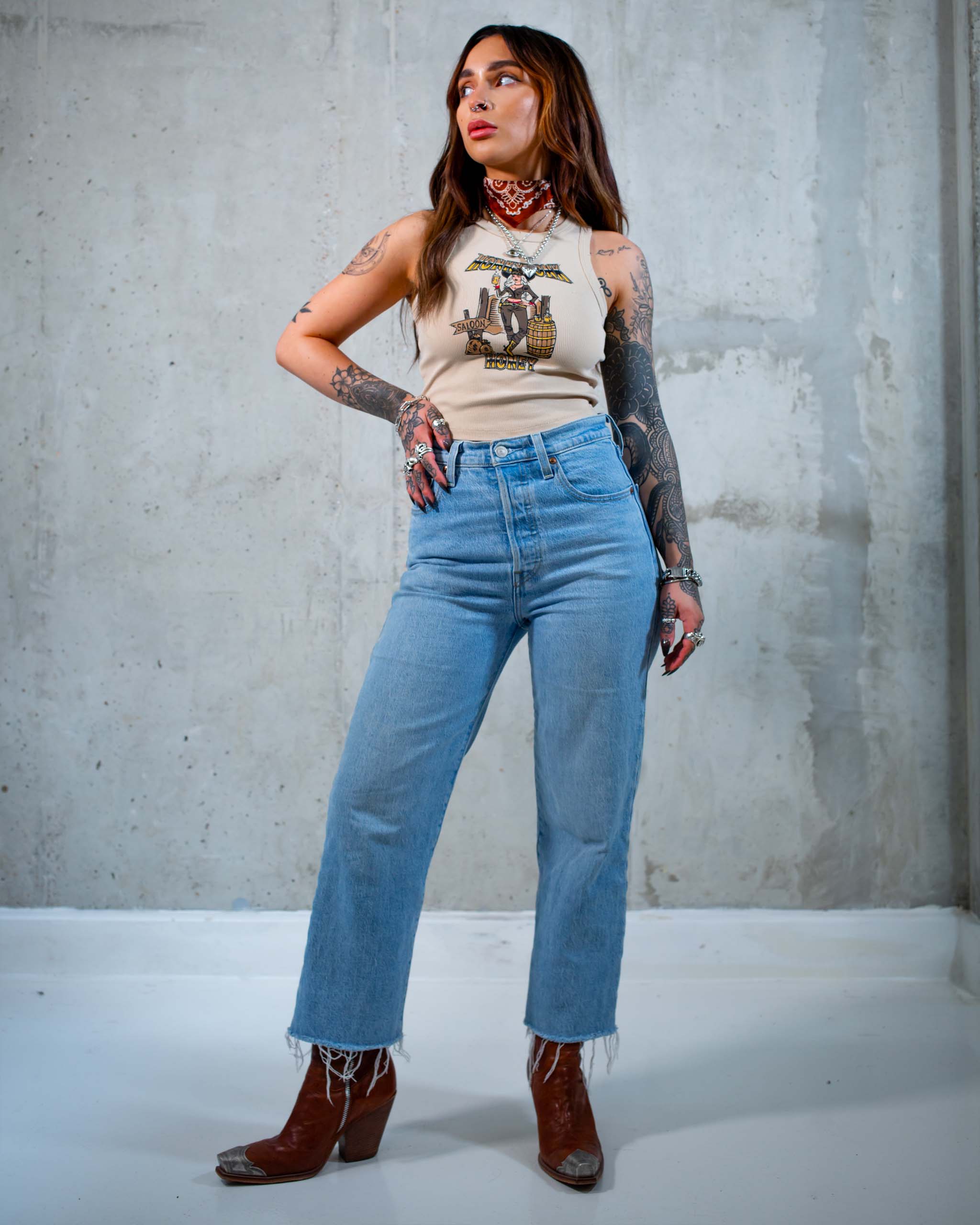 The Honkytonk Honey tank top by Sleazy Rider, featuring a cowgirl outside a wild west saloon.