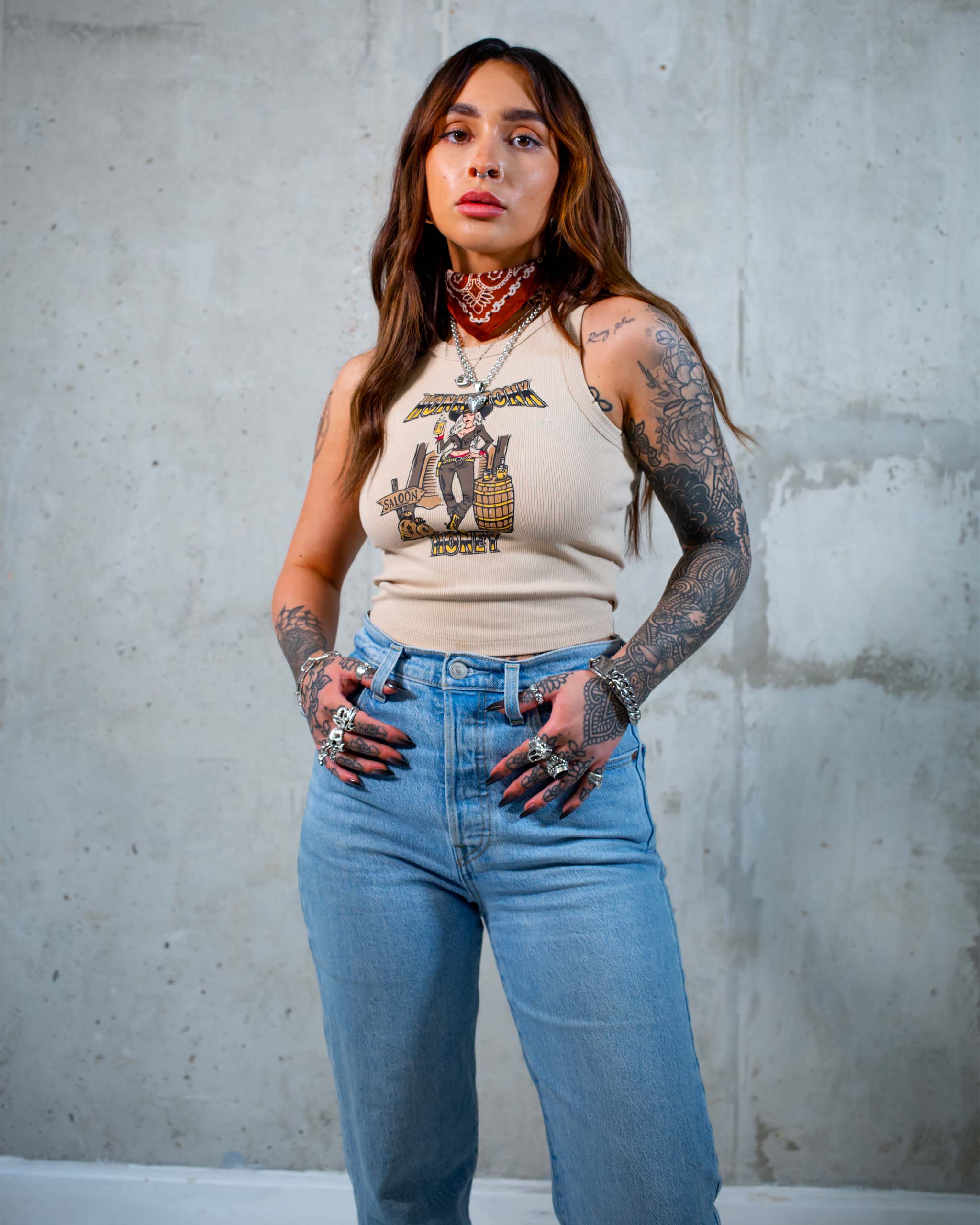 The Honkytonk Honey tank top by Sleazy Rider, featuring a cowgirl outside a wild west saloon.