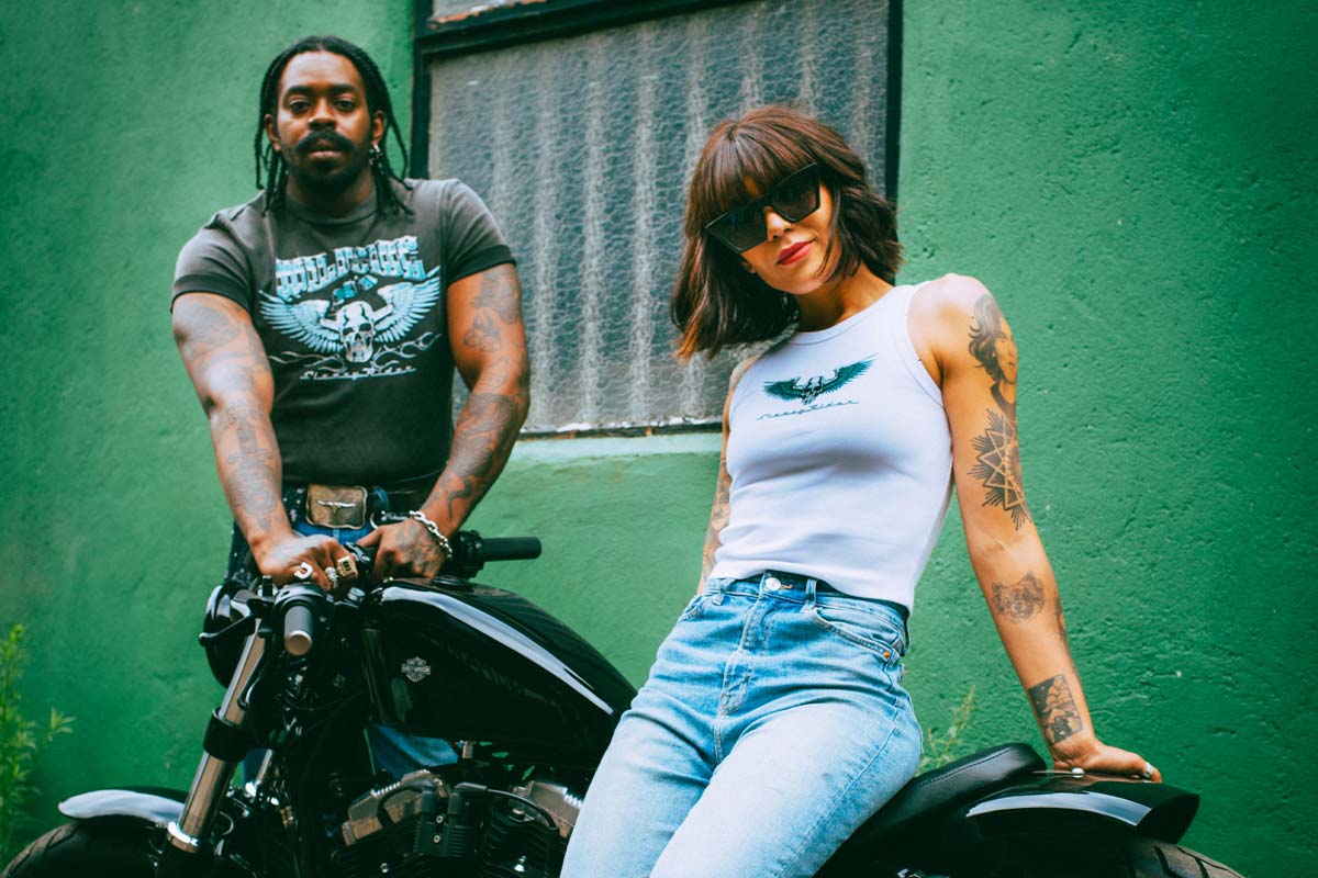 A black biker and a female biker with a Harley Davidson