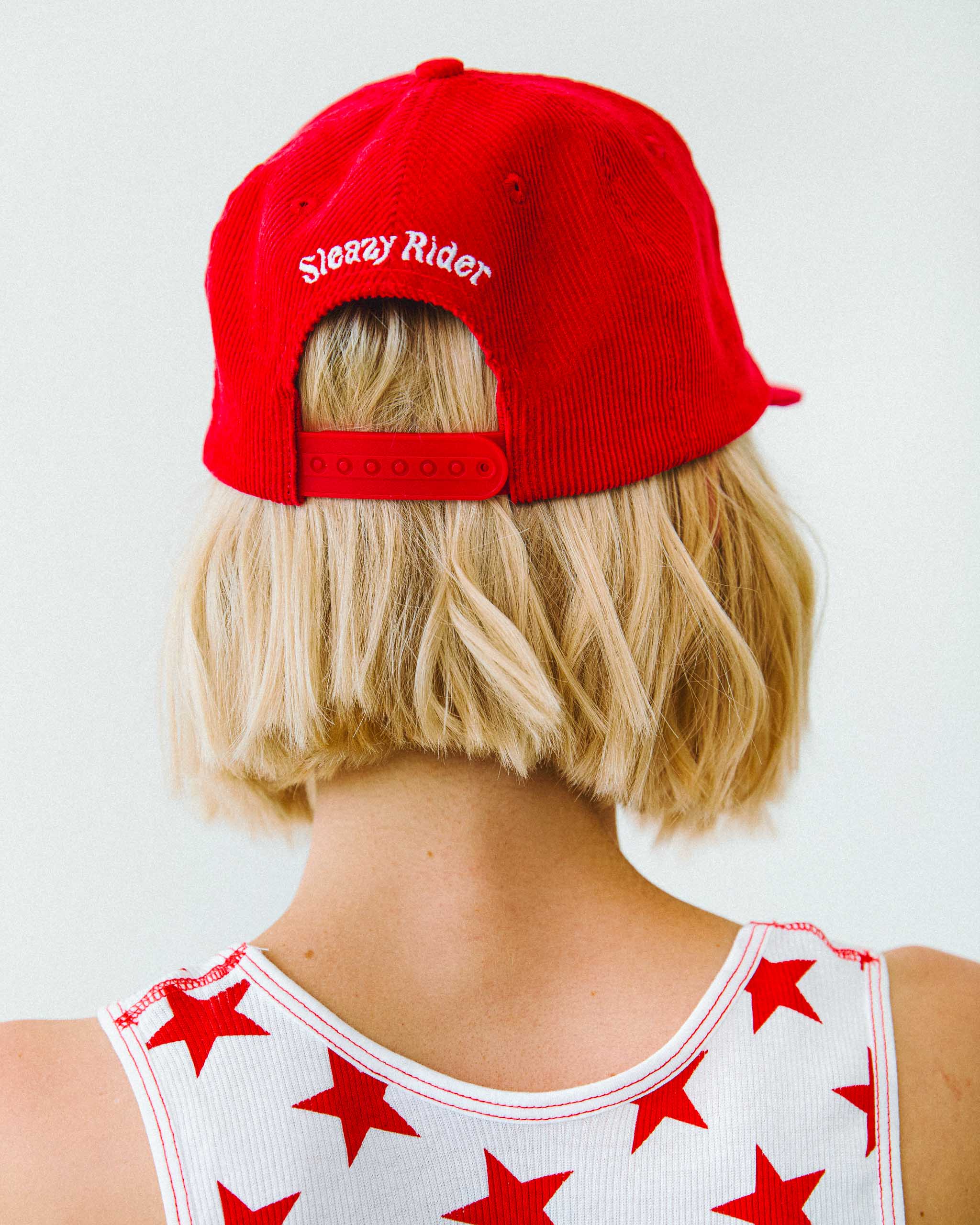 The back of a red corduroy Sleazy Rider cap.