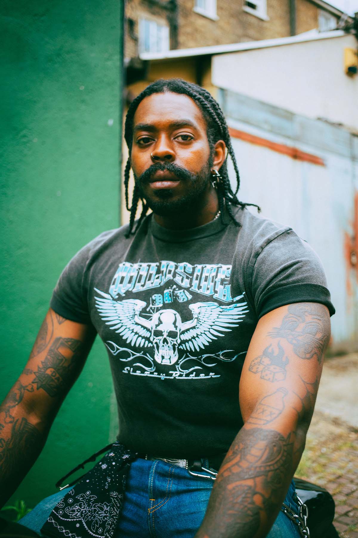 An alternative model wearing a skull with wings t-shirt