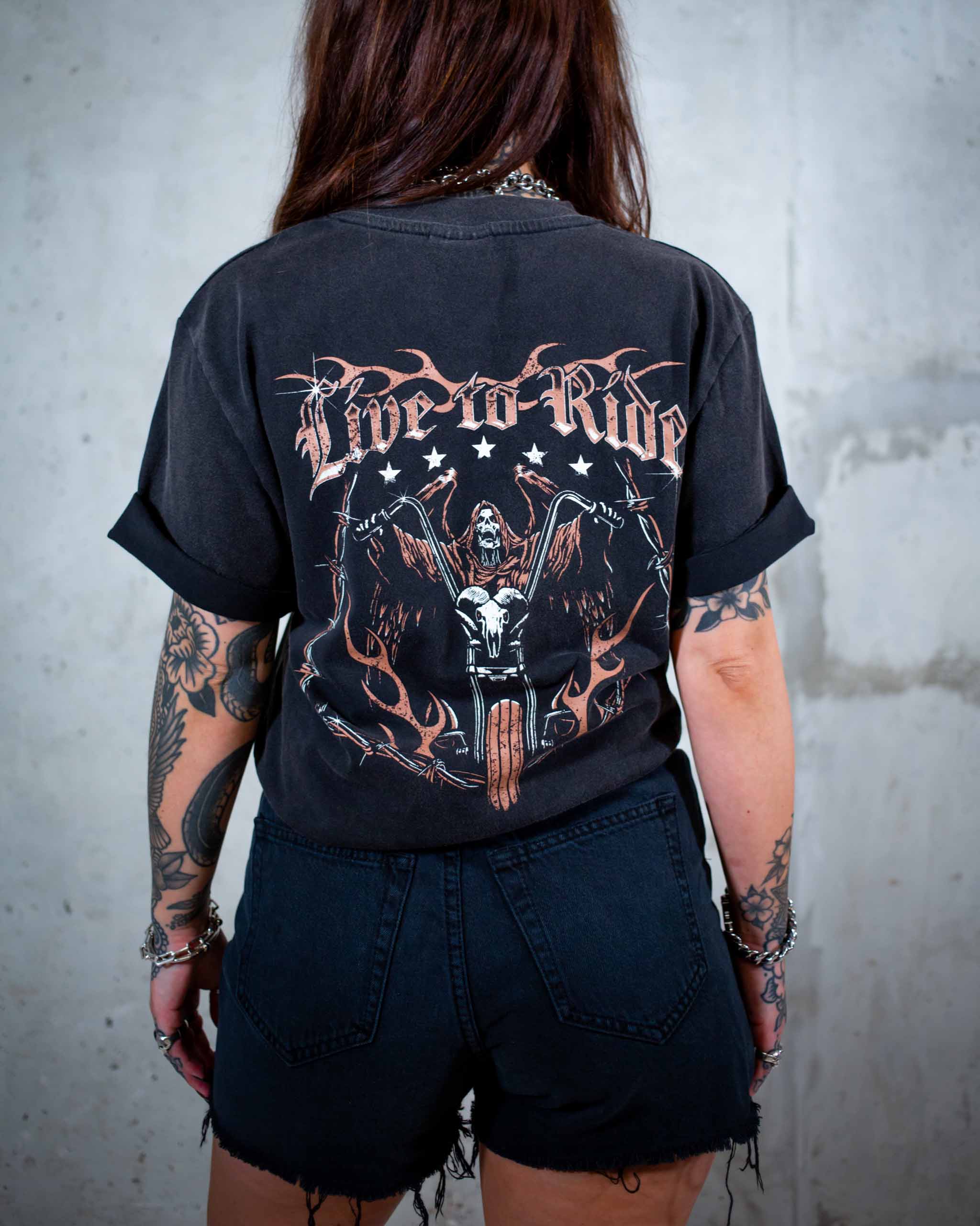 The Live To Ride biker t-shirt by Sleazy Rider. Featuring a flaming chrome skull and the grim reaper on a motorbike.