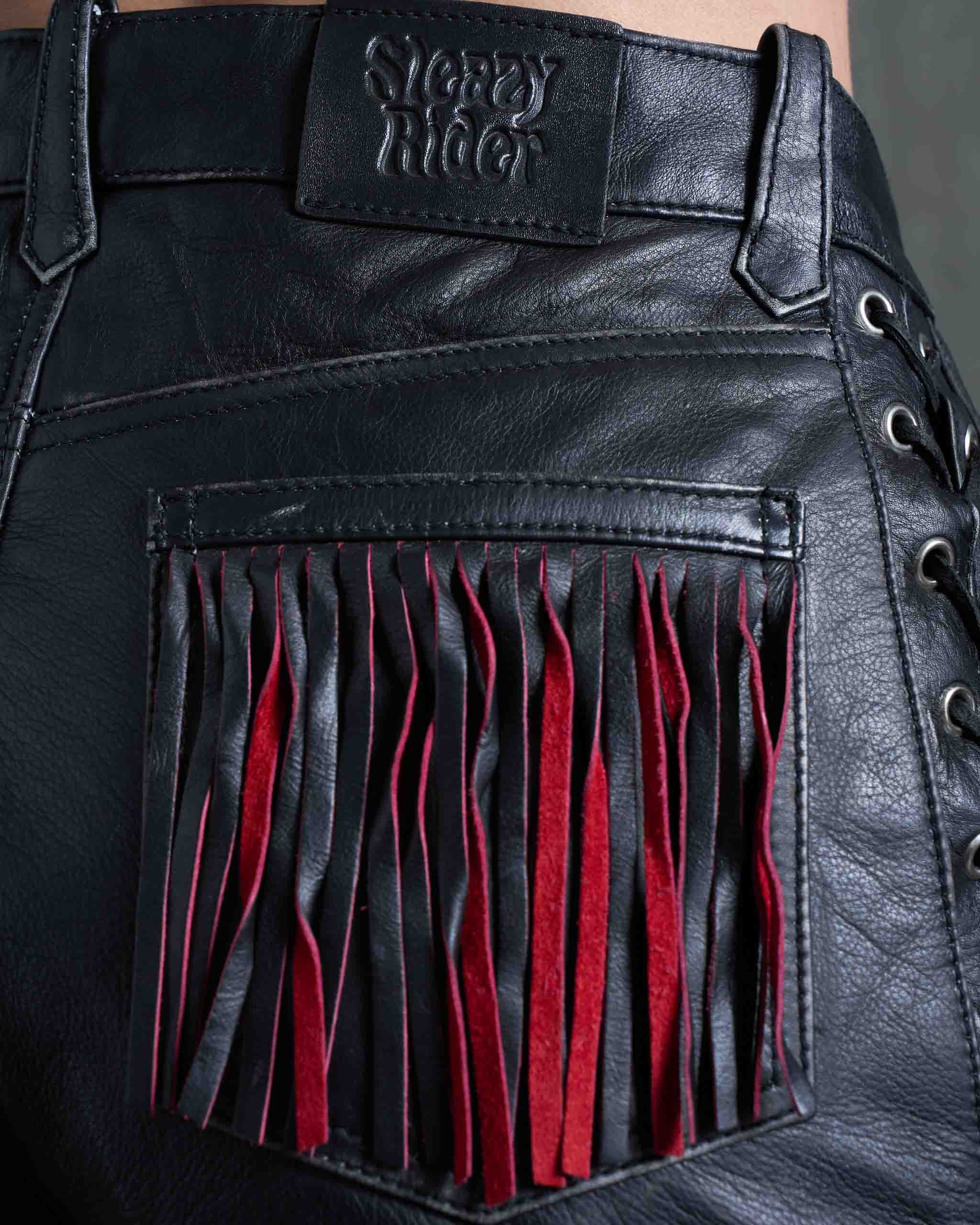 Leather biker shorts with red suede fringing and a Sleazy Rider jacron label.