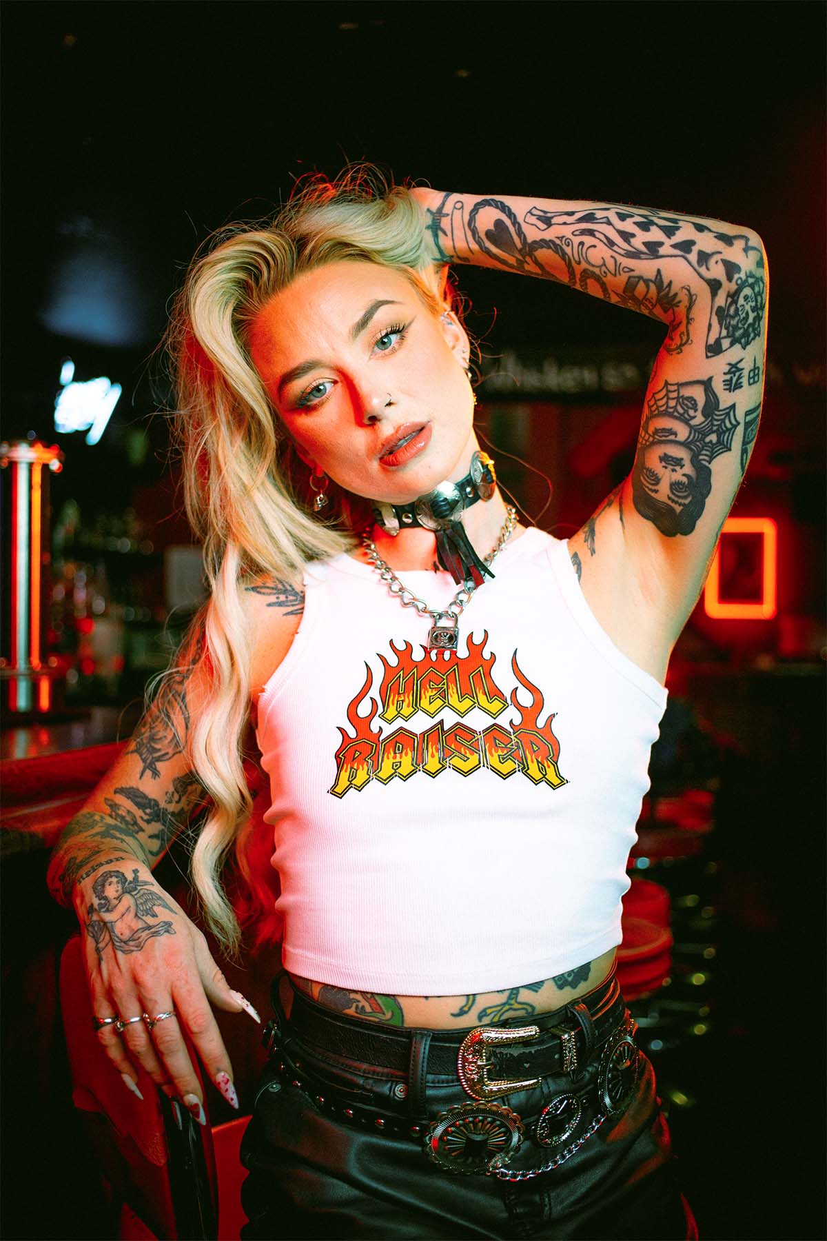Rhianon Brailsford wearing a Sleazy Rider Hell Raiser tank top in a dive bar