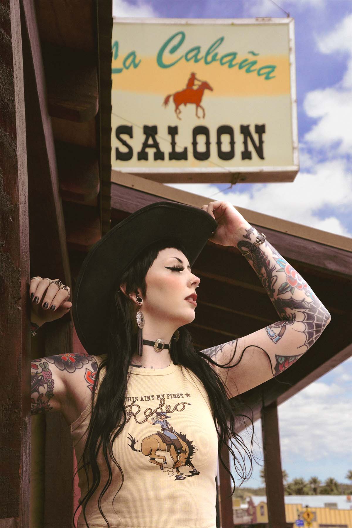 An alternative model outside a western saloon