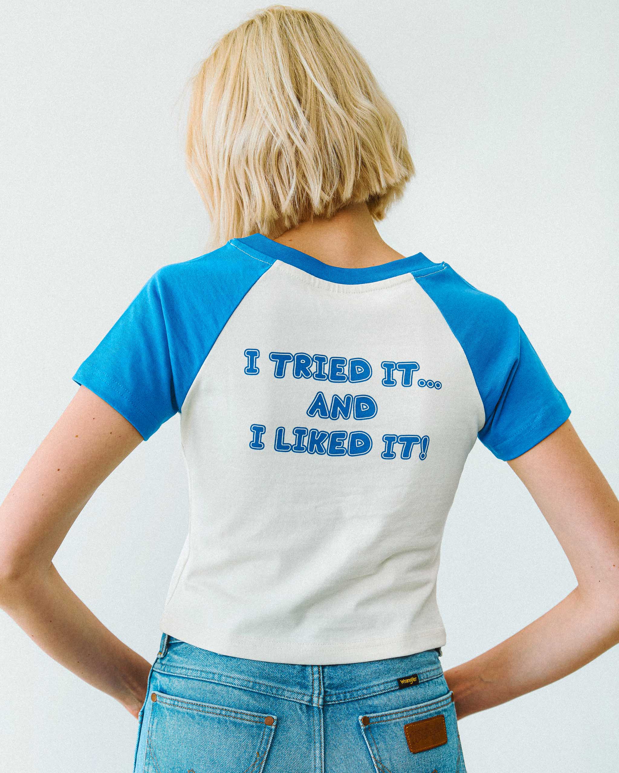 Person wearing a blue and white "I tried it.. and i liked it!' slogan t-shirt on the back, standing against a plain background.