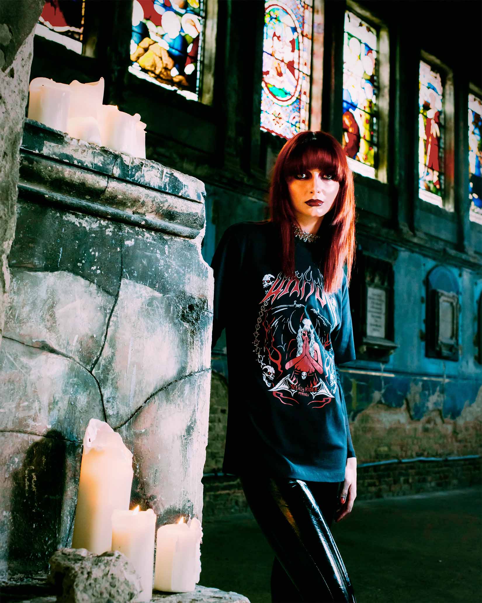 An emo girl wearing a Sleazy Rider gothic t-shirt in a spooky church