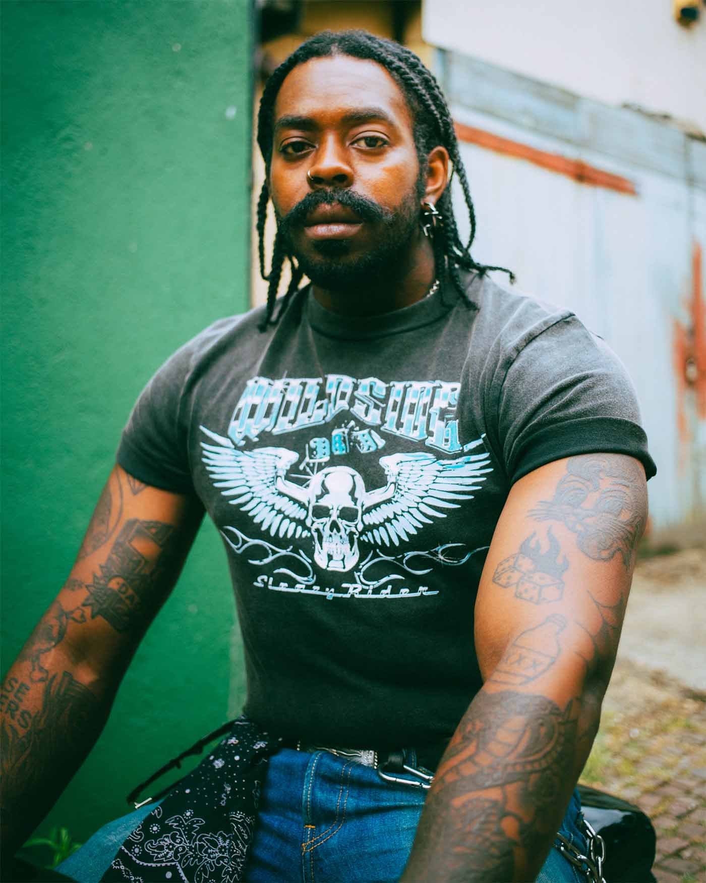 A black biker wearing a Sleazy Rider alternative t-shirt