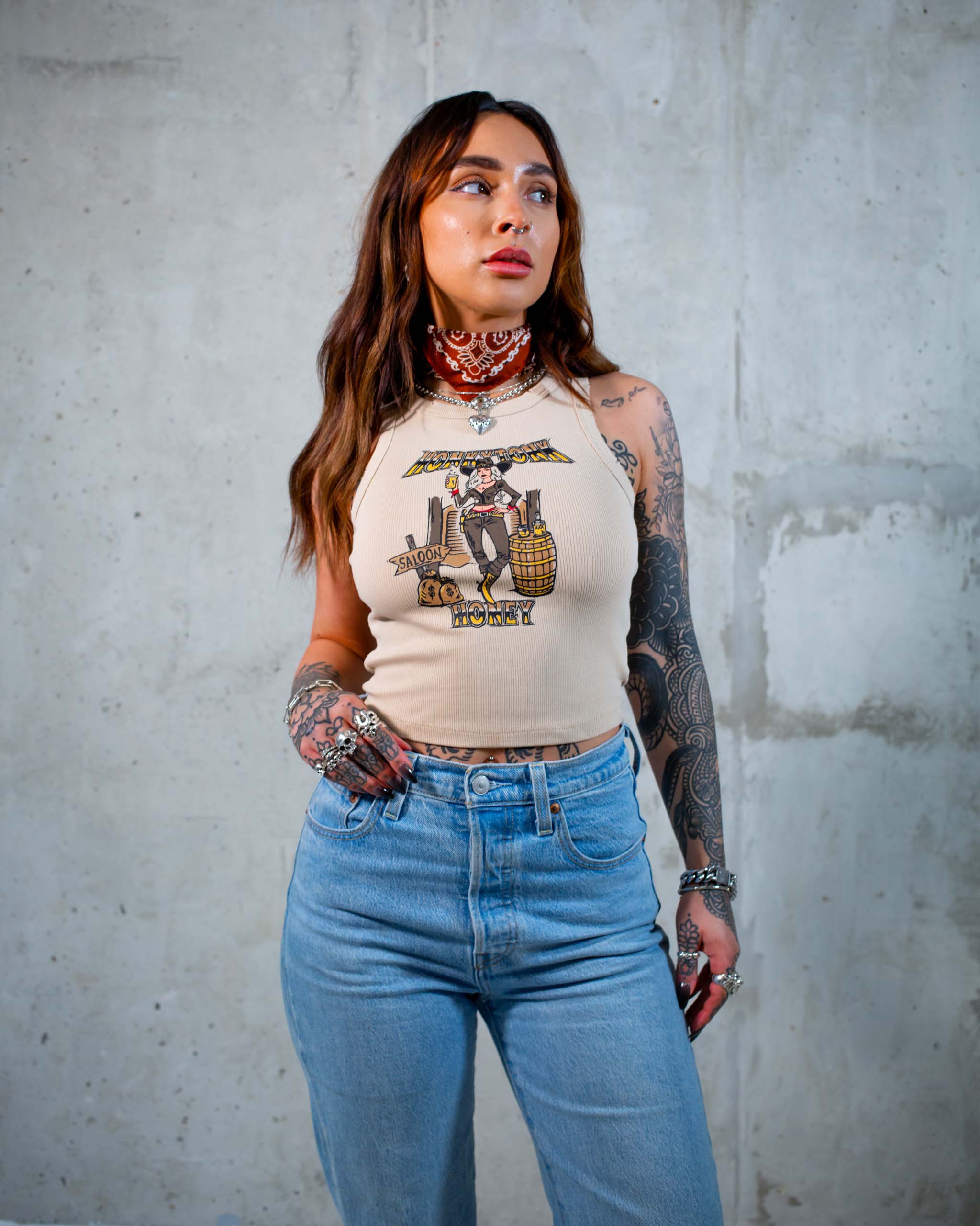 The Honkytonk Honey tank top by Sleazy Rider, featuring a cowgirl outside a wild west saloon.