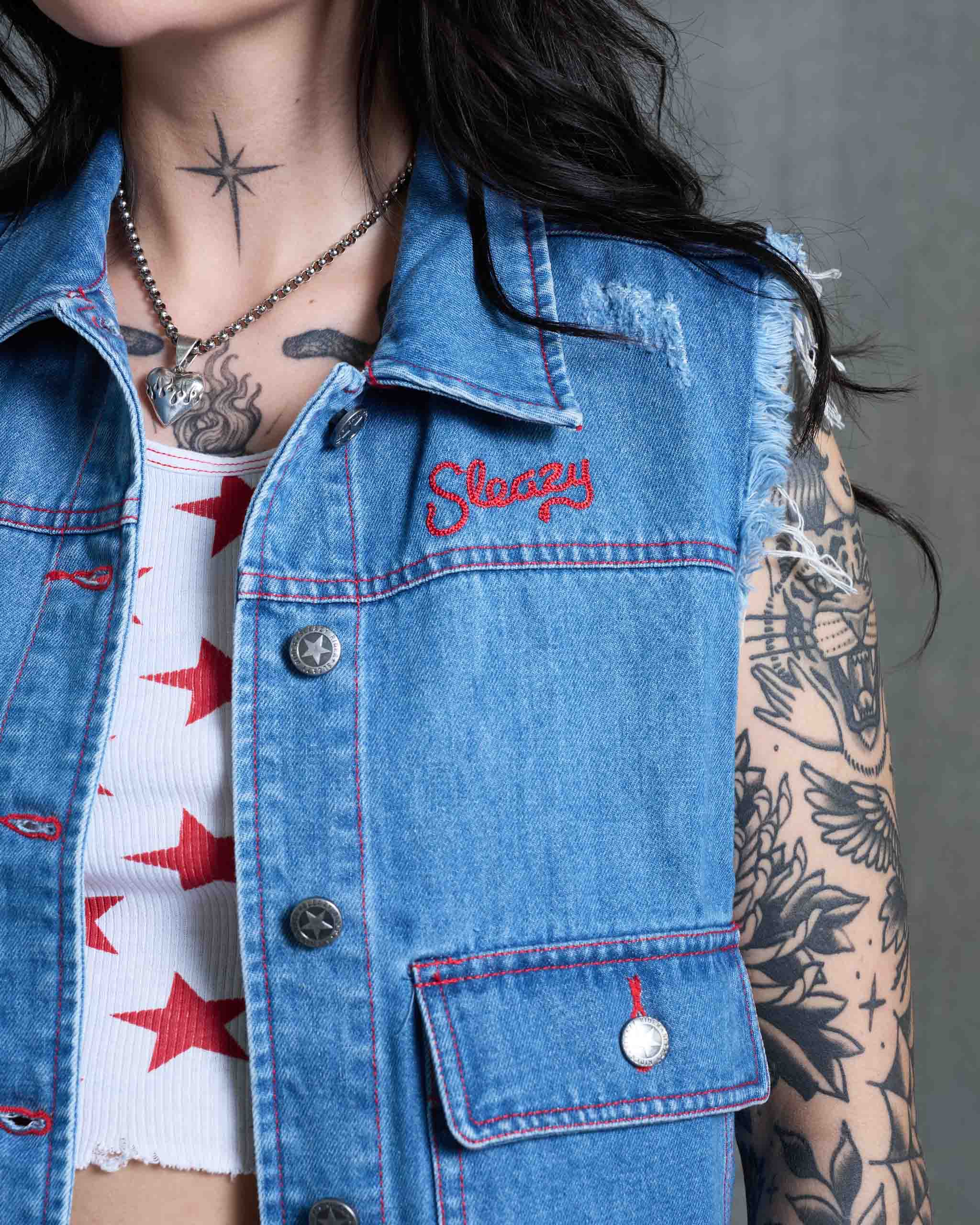 A denim vest with 'Sleazy' embroidery.