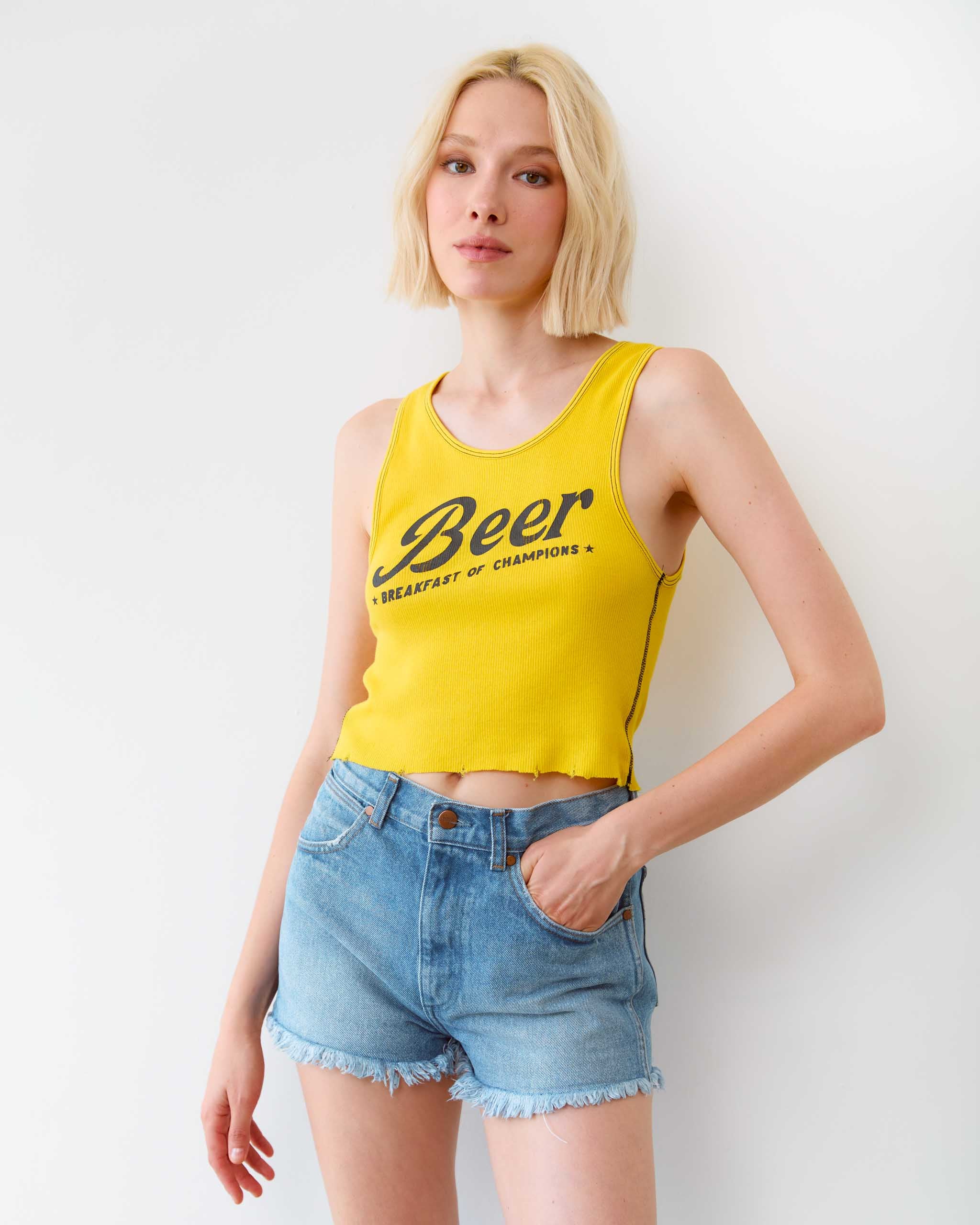 A woman wearing a 'Beer, Breakfast of Champions' tank top.