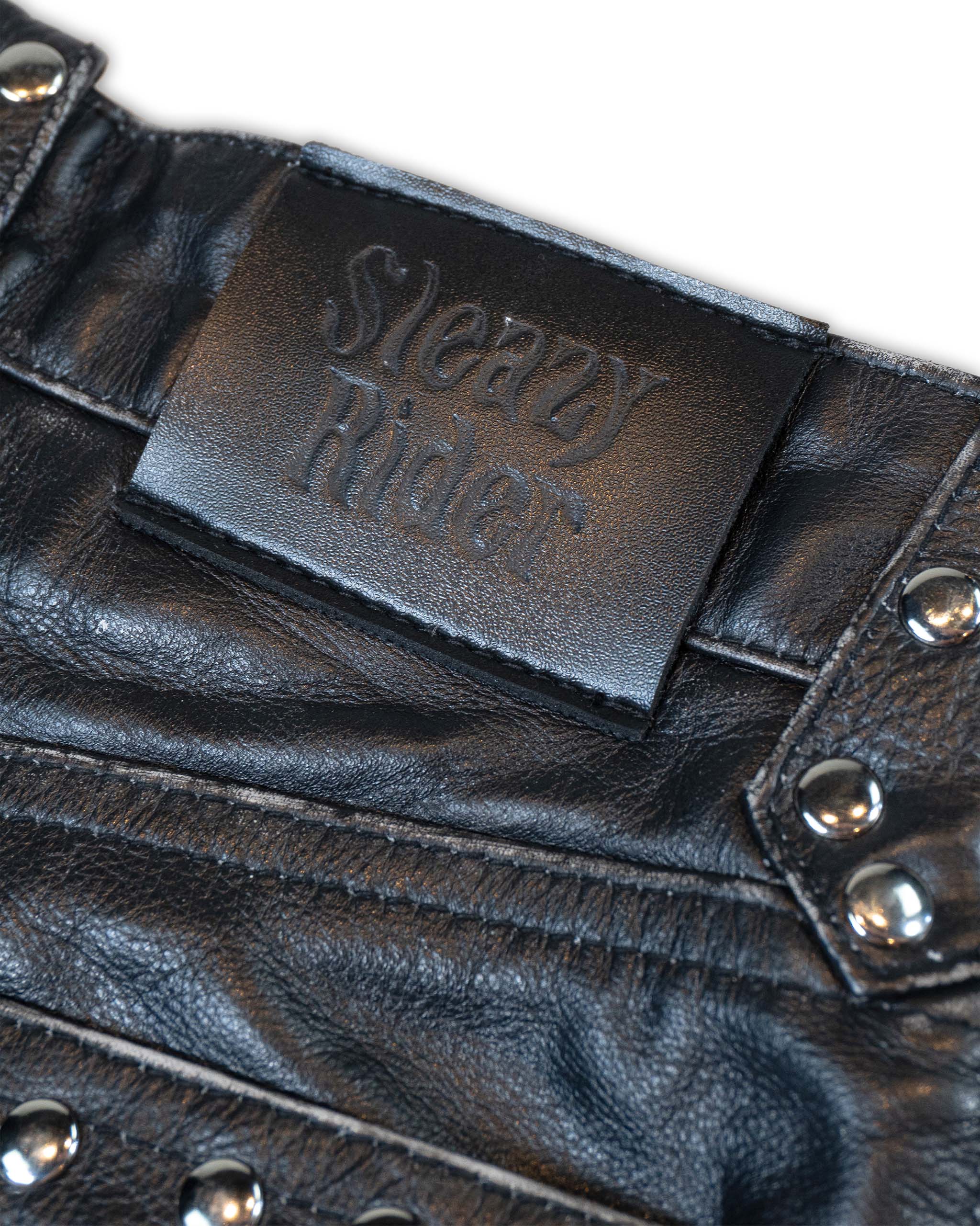 Close-up of a black leather jacket with 'Sleazy Rider' branding.