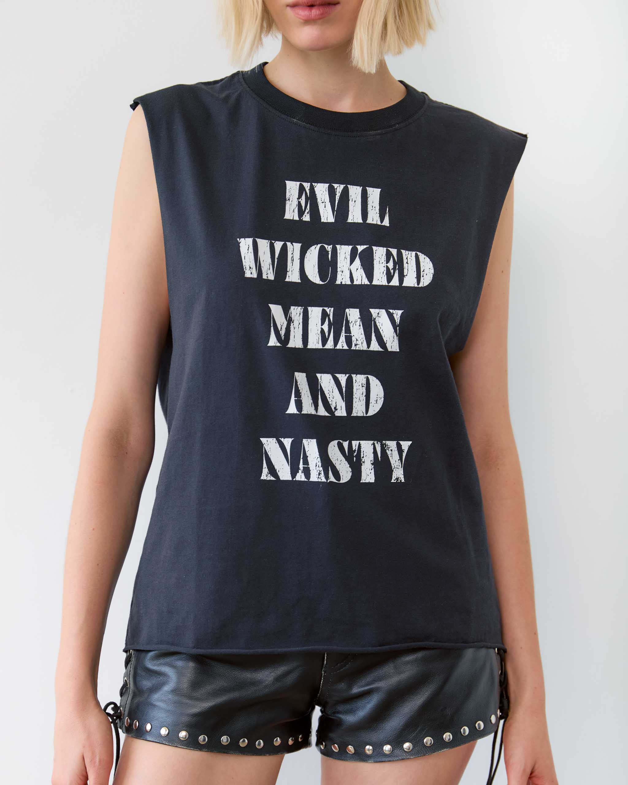 Person wearing a black sleeveless shirt with 'EVIL WICKED MEAN AND NASTY' printed on it.