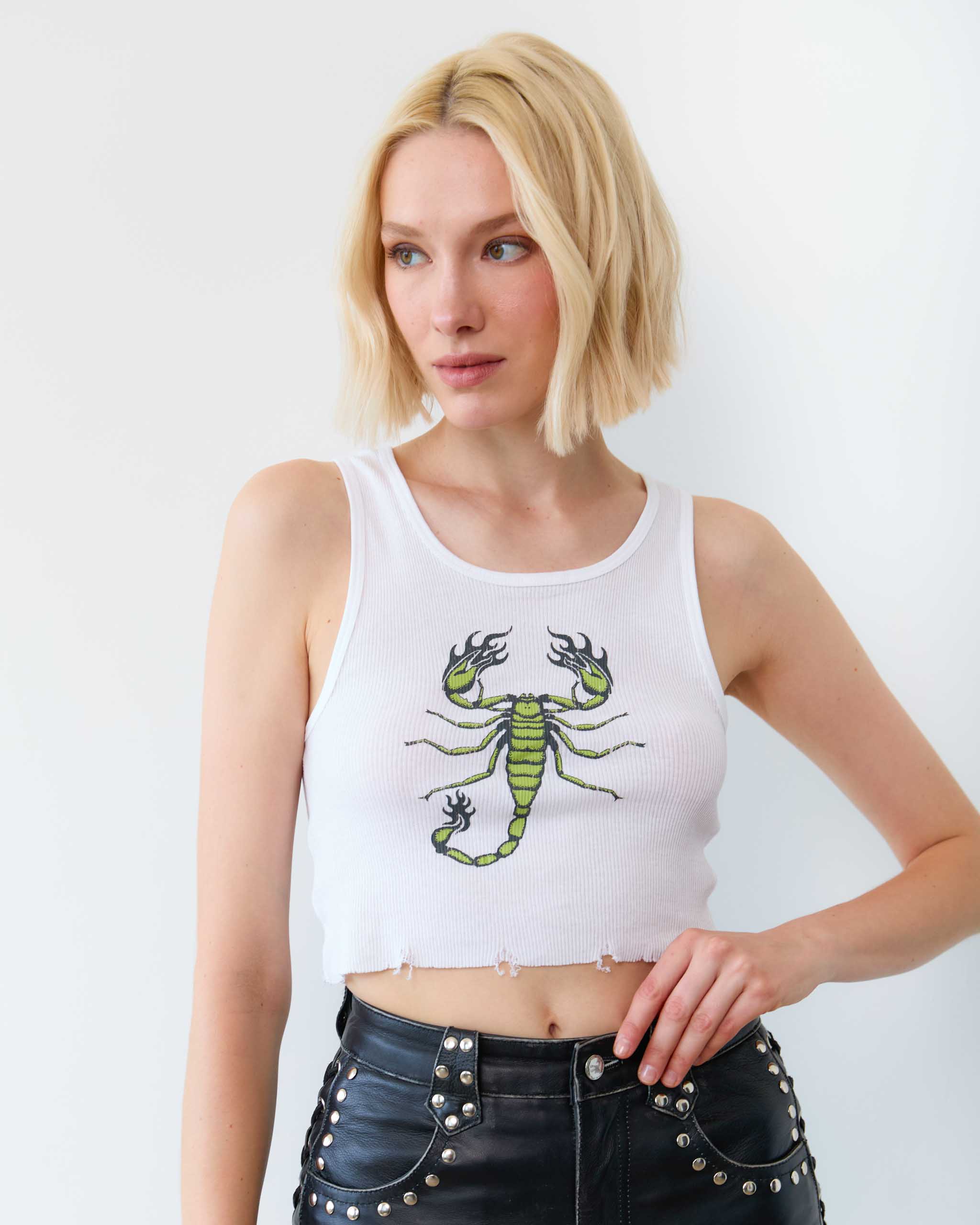 A woman wearing a green scorpion tank top.