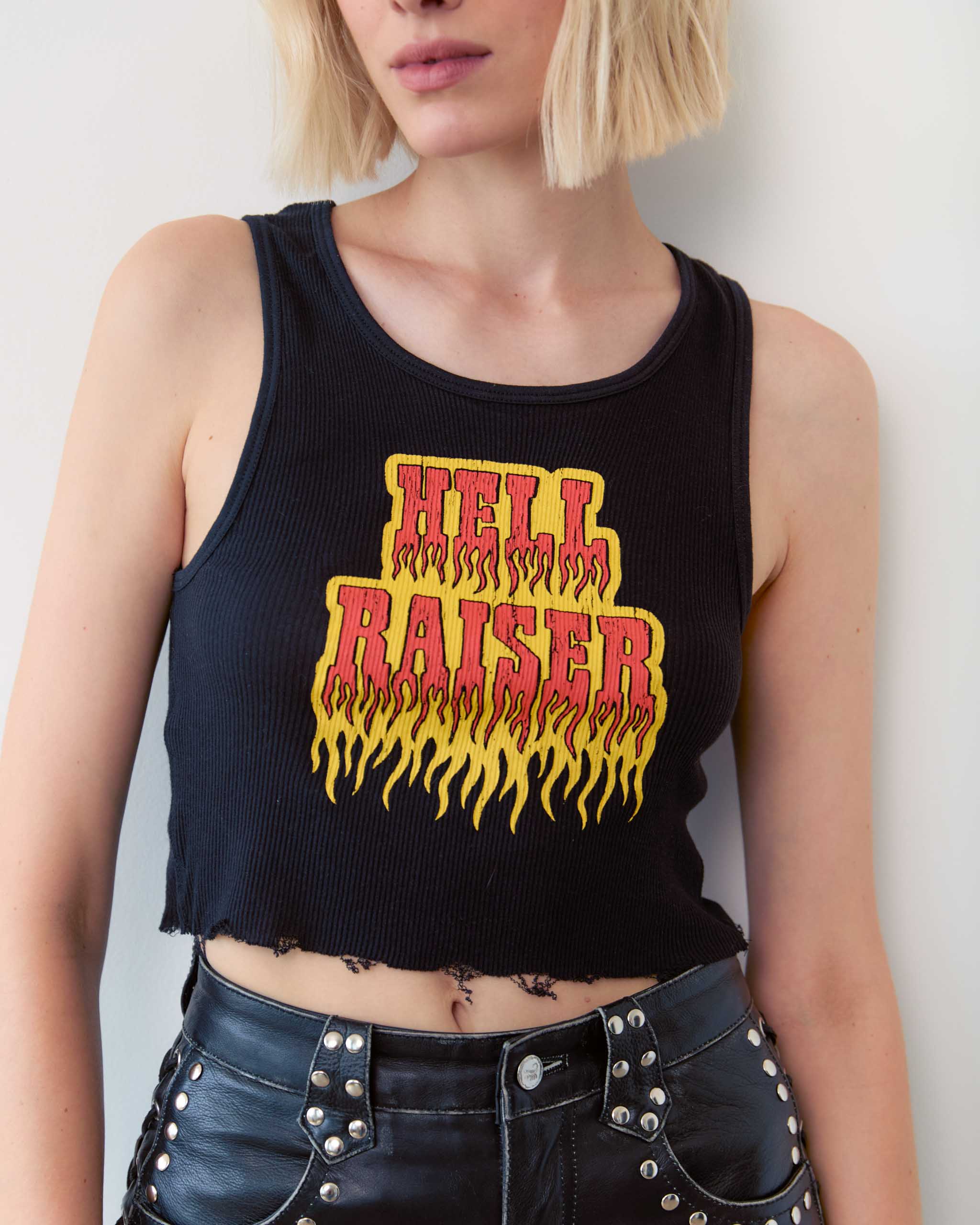 A woman wearing a tank top with 'Hell Raiser' printed on it in a flaming font.