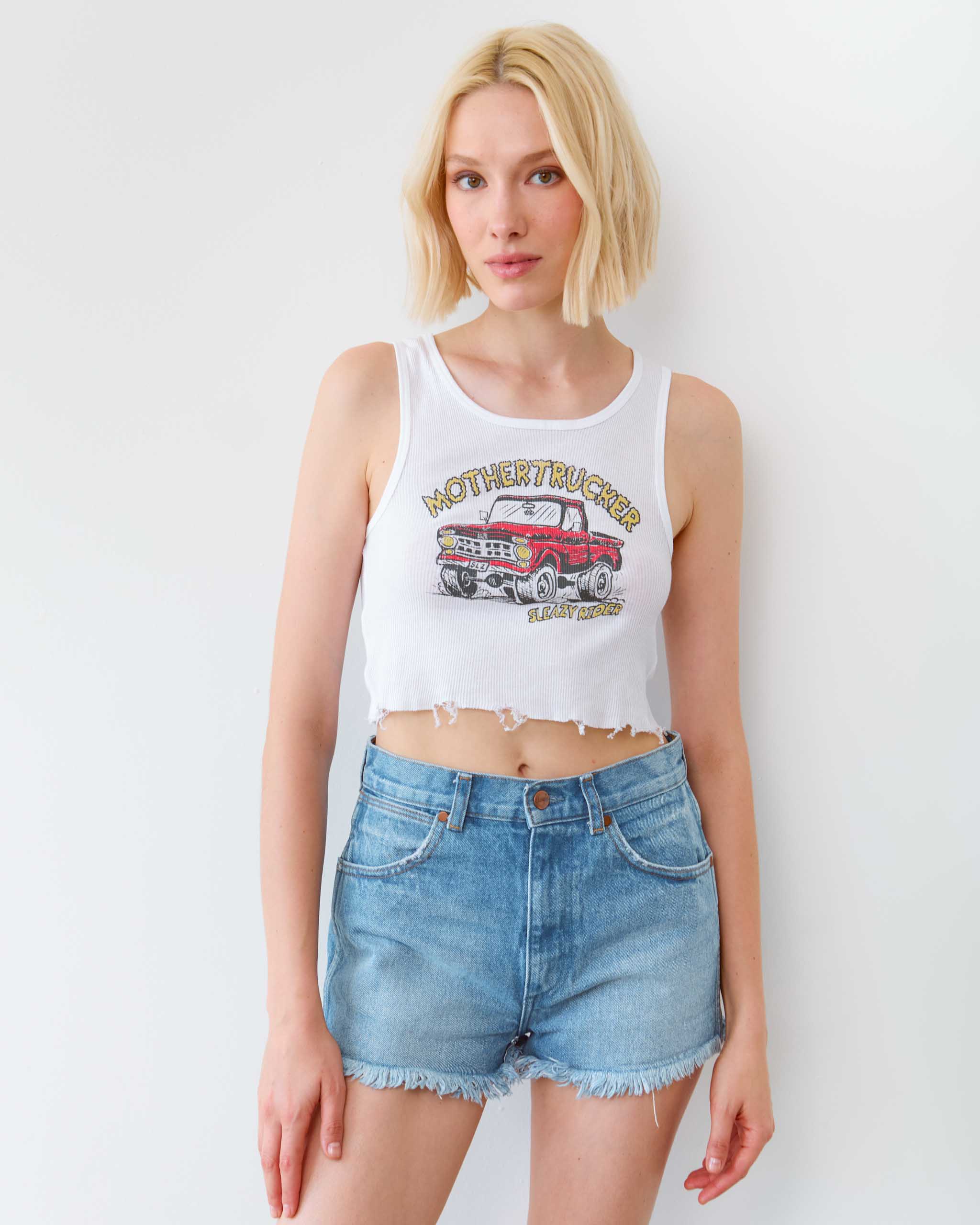 A model wearing a 'Mothertrucker' tank top.