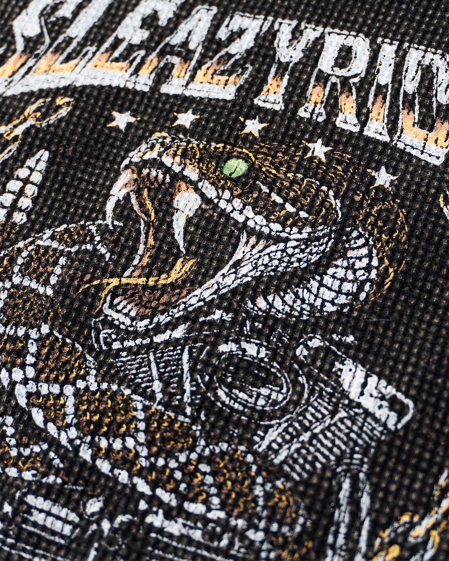 A close up of a vintage style rattlesnake biker tee screen print.