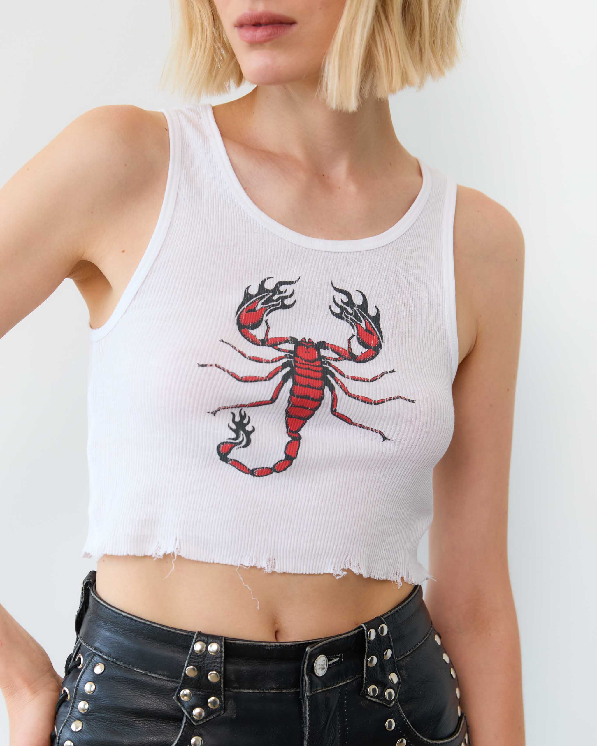 A woman wearing a red scorpion tank top.
