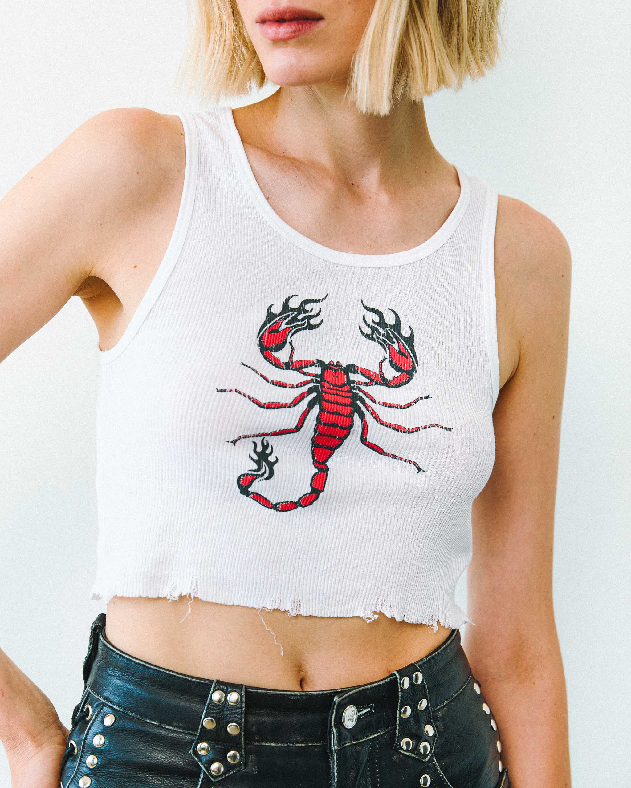 A white biker tank top with a flaming scorpion print, on a plain background.
