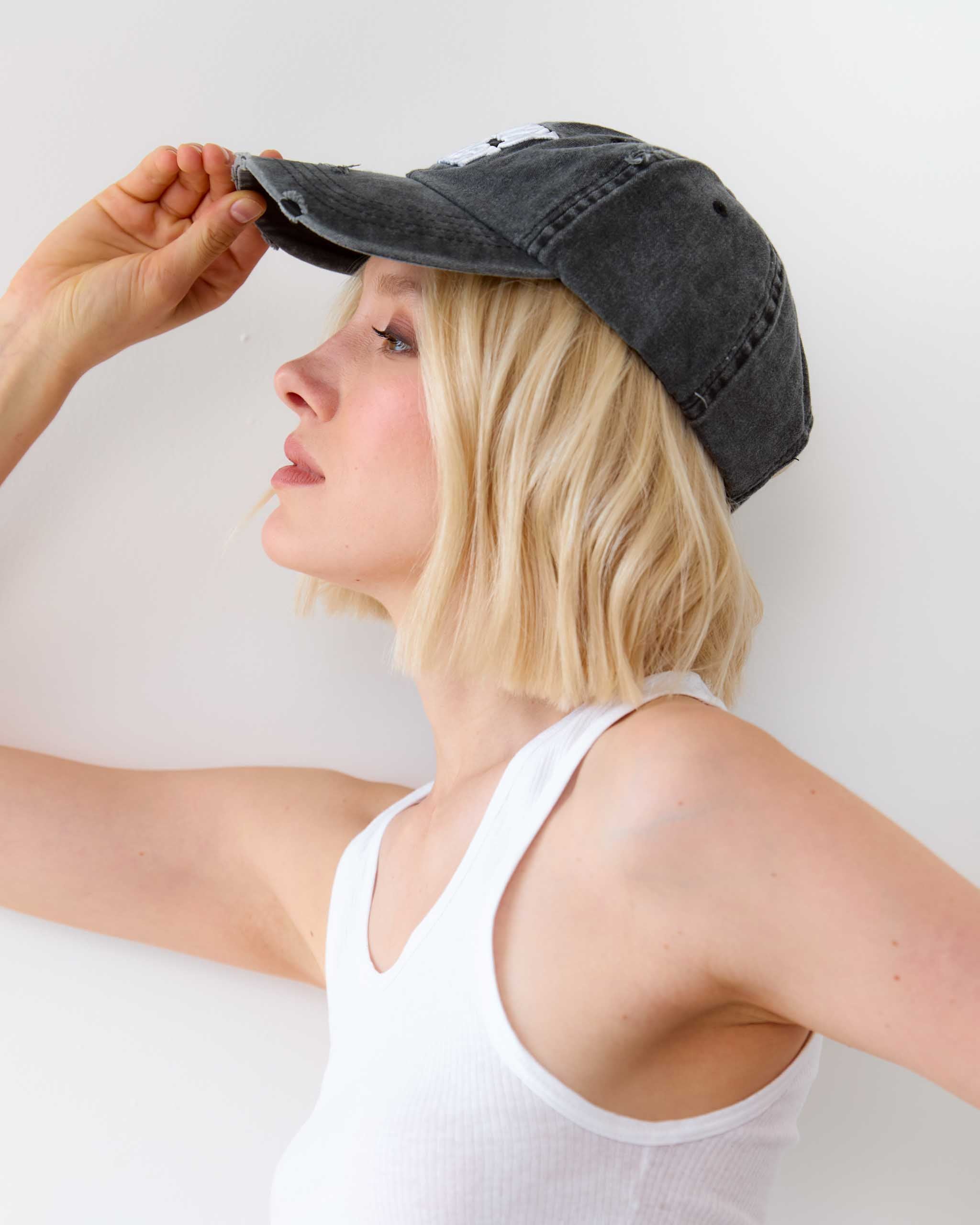 Side view of the Sleazy Rider distressed cap.
