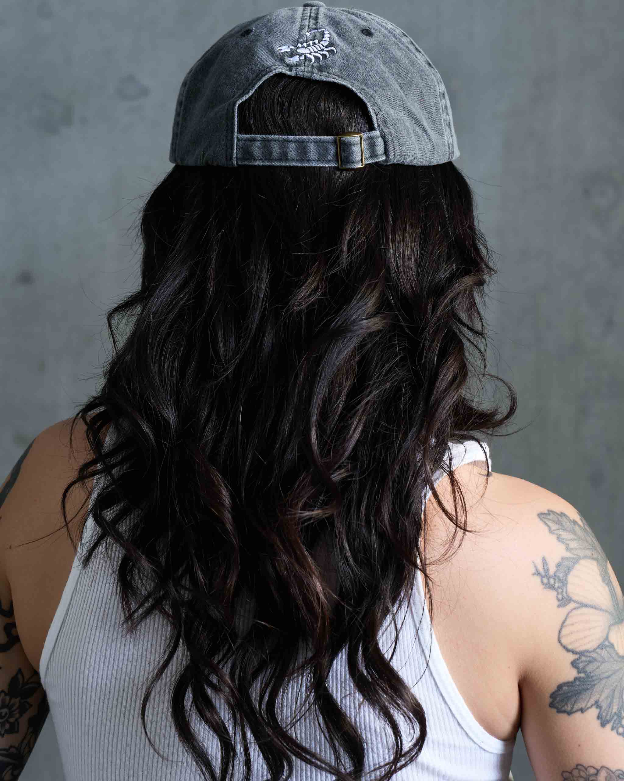 Back view of a Sleazy Rider cap with scorpion embroidery.