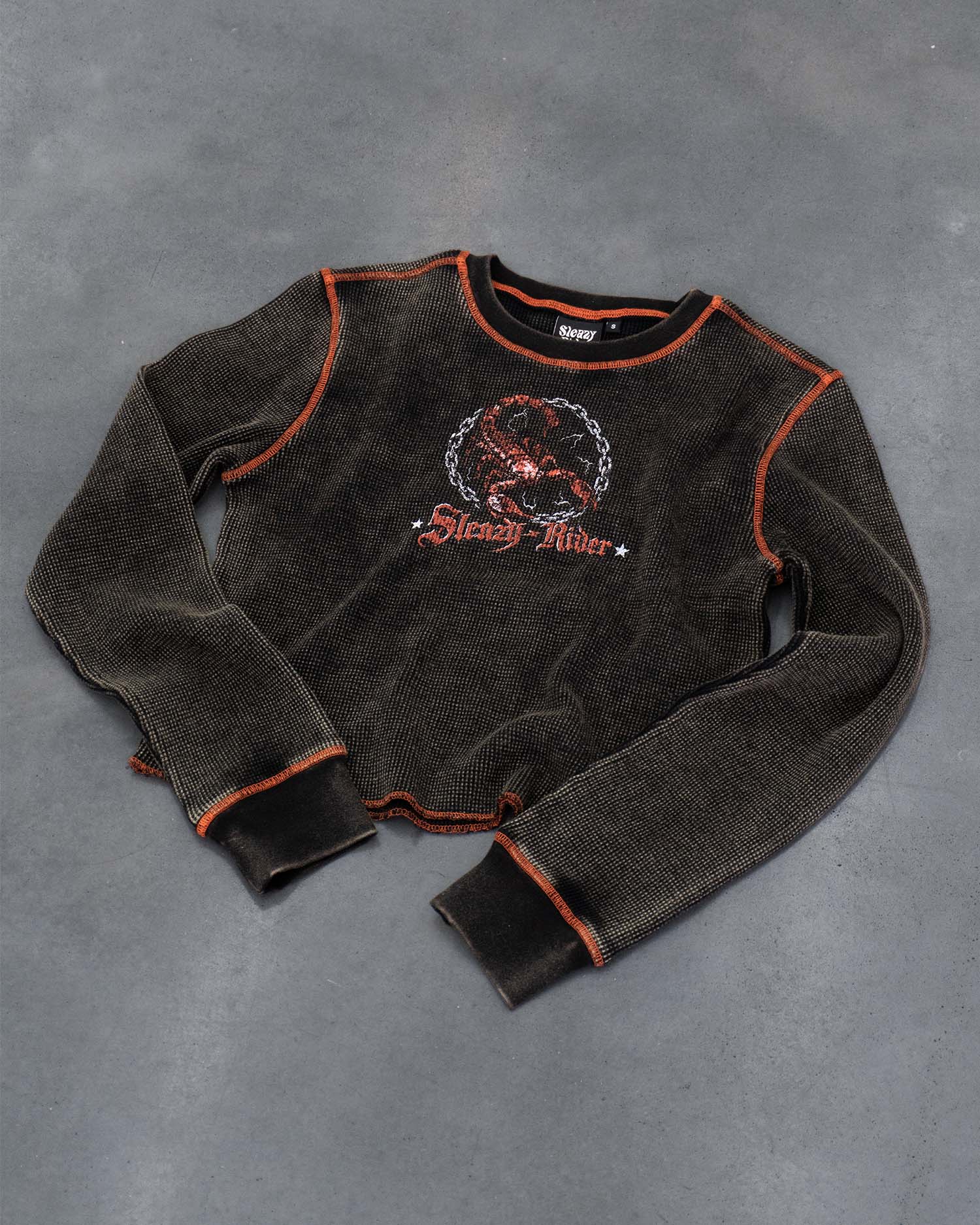 A waffle knit long sleeve top with a heavy acid wash, scorpion screen print and orange contrast stitching.