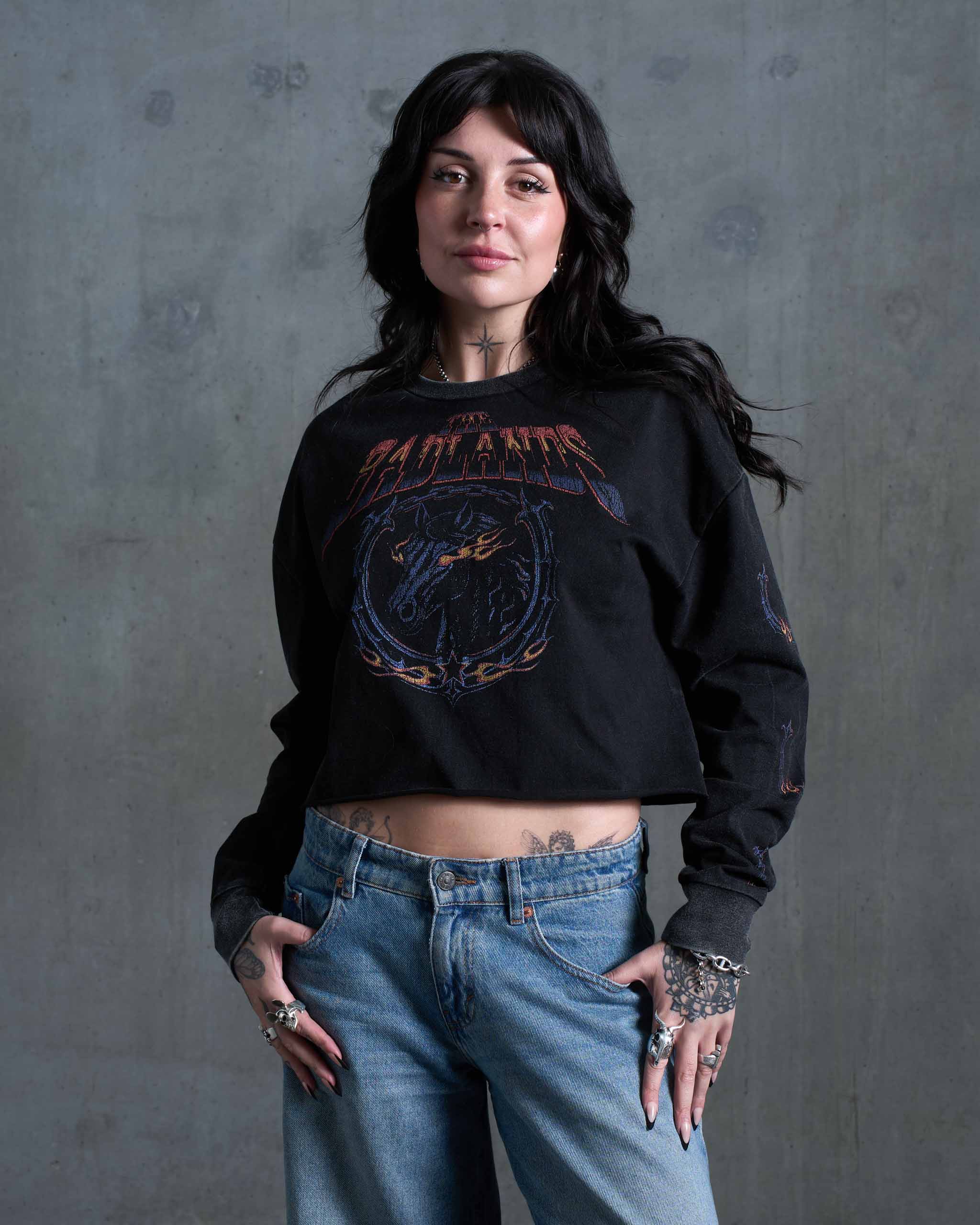 A woman wearing a vintage biker long sleeve t-shirt, similar to a Harley Davidson t-shirt.